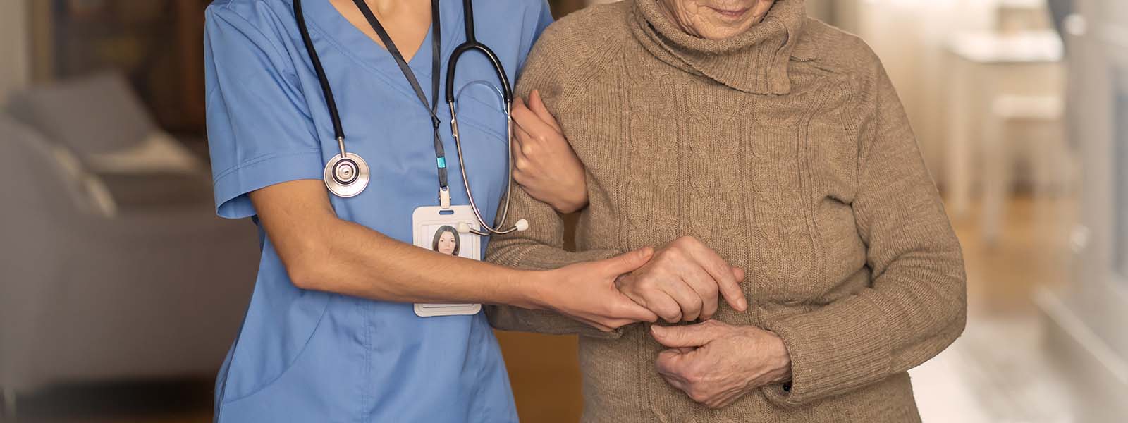 A young nurse shows care and professionalism in relation to an elderly woman